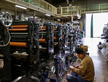 FILE PHOTO: A worker checks machinery at a factory in Higashiosaka, Japan June 23, 2022.  REUTERS/Sakura Murakami