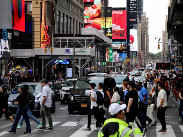 People cross a busy street near Times Square, New York City on June 16, 2023. People classified as overweight though not obese are not at a higher risk of death, according to a new study July 5, 2023 that underscores the clinical limitations of body mass index (BMI), long a standard medical metric.