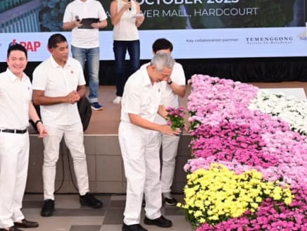 Prime Minister Lee Hsien Loong places the final pot of flowers to complete a floral map of Singapore formed by close to 1,000 pots of chrysanthemum plants of different colours at the LKY100 The Greening of Singapore commemoration ceremony on Oct 29, 2023.