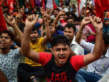 Activists from Bangladeshi garments organization hold a rally in Dhaka on Sept 14, 2018, to demand a mandatory monthly minimum wage. 
