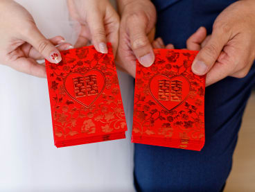 Red packets are traditionally given as tokens of good wishes during Chinese weddings.